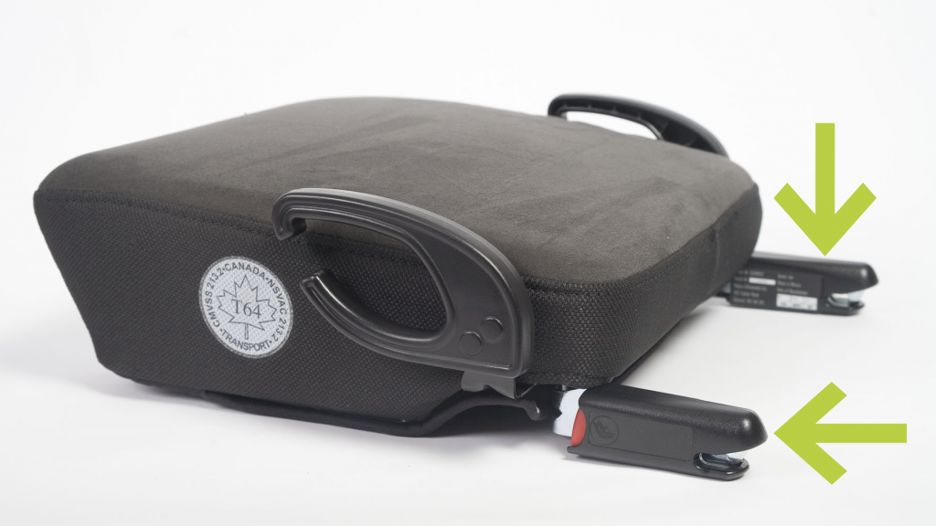 Green arrows point to the Universal Anchorage System (UAS) connectors on a booster seat